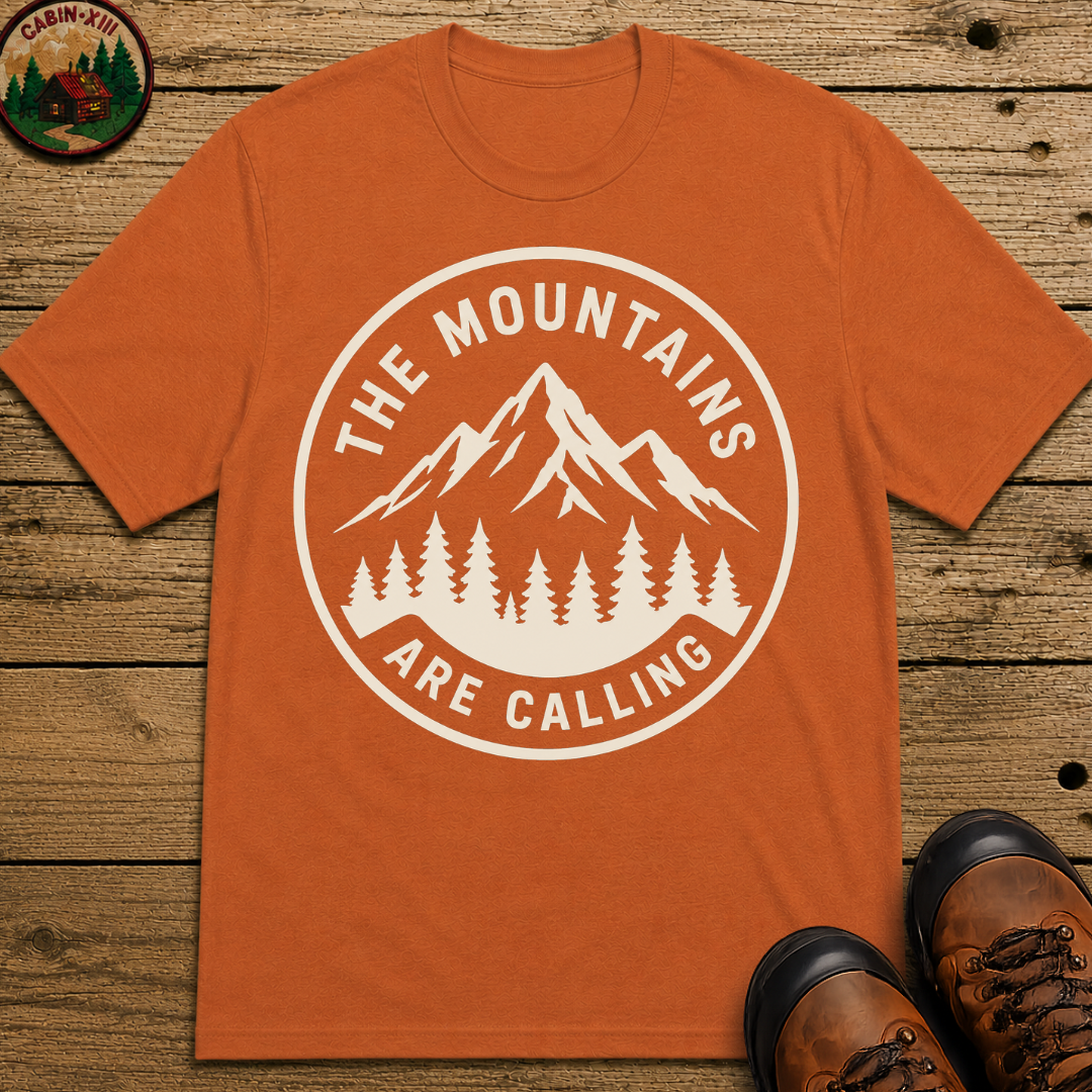 The Mountains Are Calling — Vintage Hiking Outdoor Badge Tee