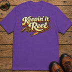 Keepin' It Reel — Retro Fishing Humor Tee - Grape